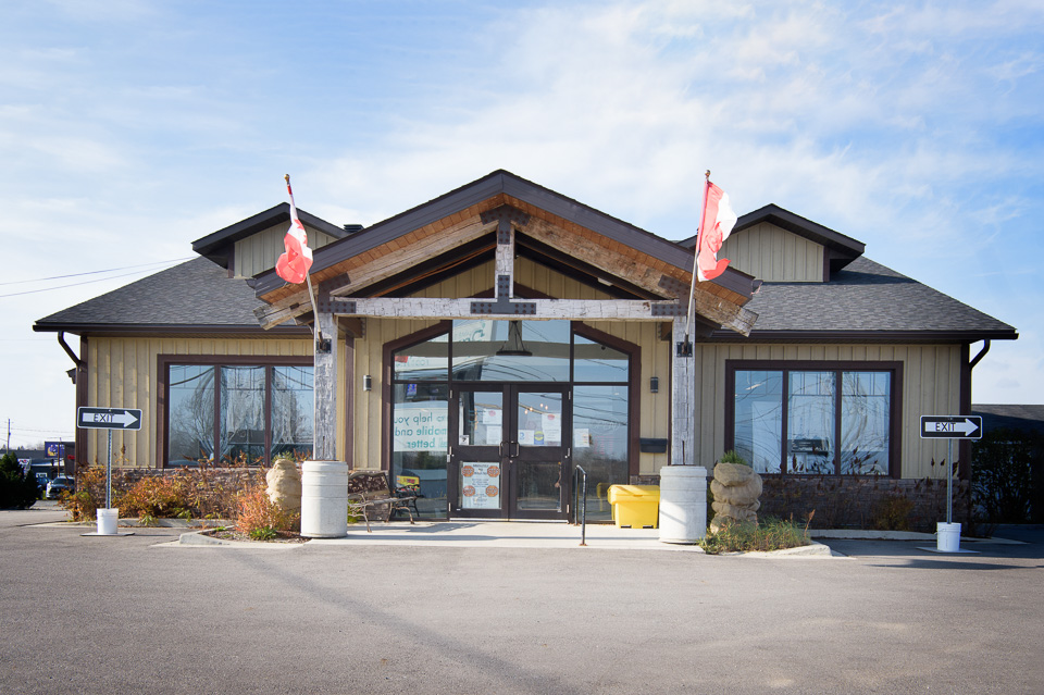 Front entrance with timber-frame porch and glass doors